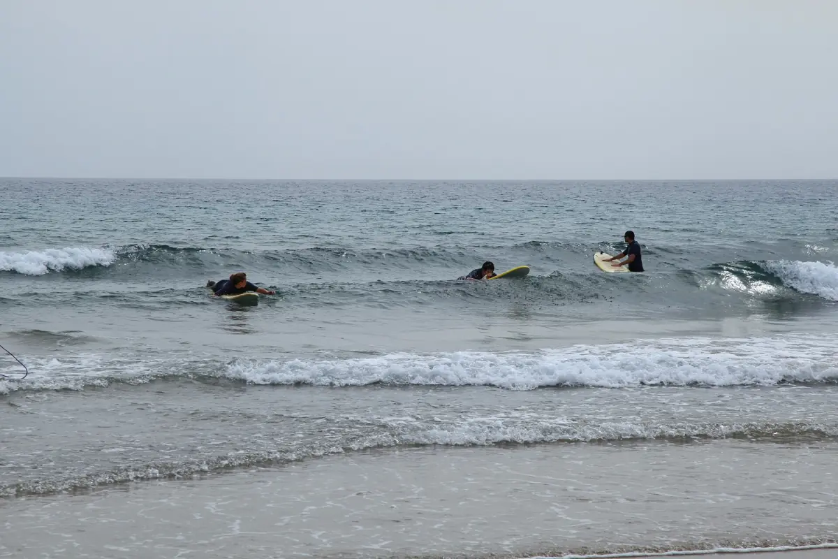 Surfers in the waves at Playa Blanca